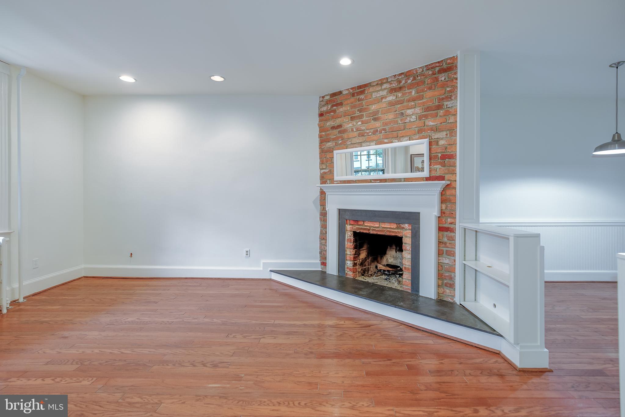 323 14th Street Northeast Washington, DC 20002 - Photo 12 of 41 a view of an empty room with wooden floor fireplace and a window