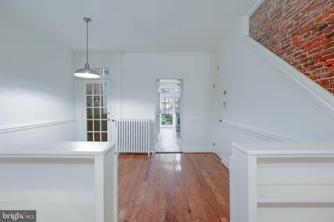 a view of a room with wooden floor and staircase
