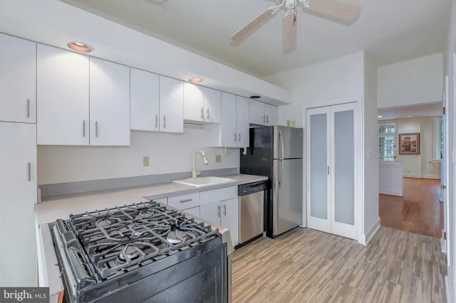 a kitchen with stainless steel appliances granite countertop a stove and a refrigerator