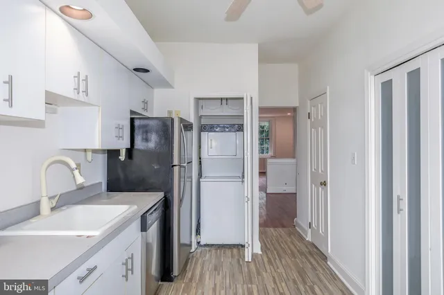 a kitchen with a refrigerator sink and cabinets