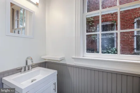 a bathroom with a sink and a window