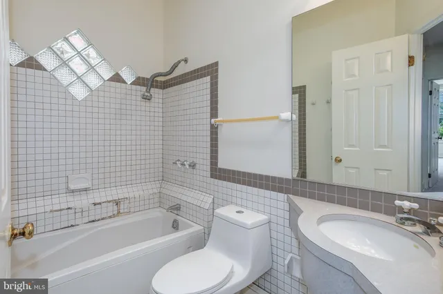 a bathroom with a sink a mirror and shower