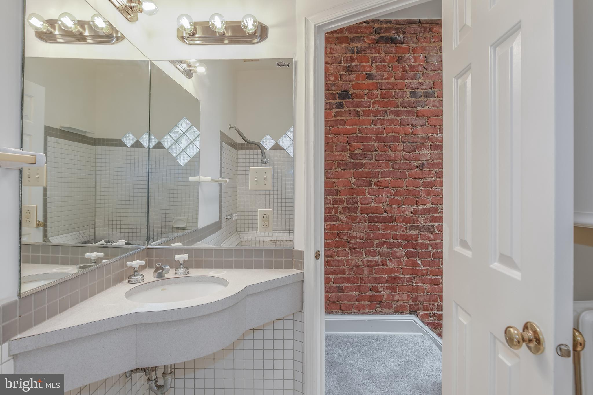 323 14th Street Northeast Washington, DC 20002 - Photo 35 of 41 a bathroom with a sink a mirror and shower