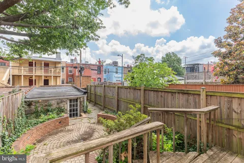 a view of a brick building next to a yard
