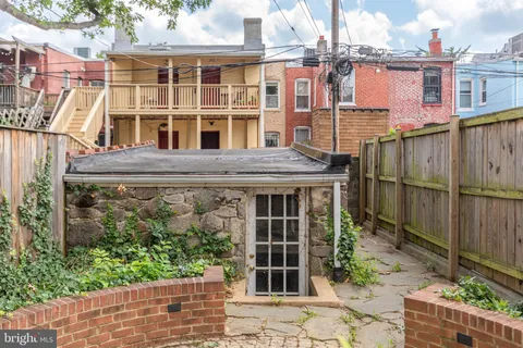 a view of a patio with table and chairs with wooden fence and plants