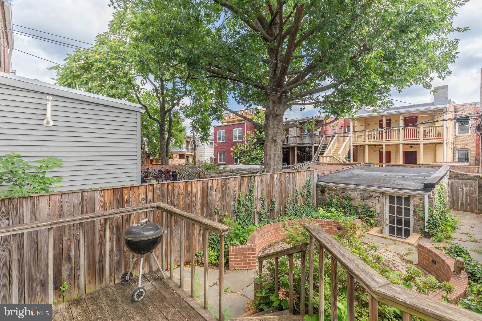 323 14th Street Northeast Washington, DC 20002 - Photo 39 of 41 a view of a patio with table and chairs with wooden fence and plants