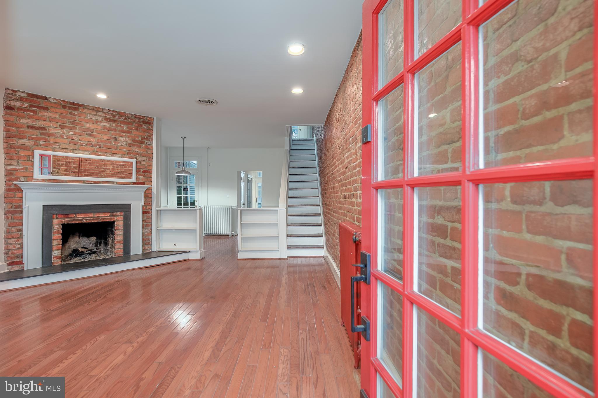 323 14th Street Northeast Washington, DC 20002 - Photo 6 of 41 a view of an empty room with wooden floor and a fireplace