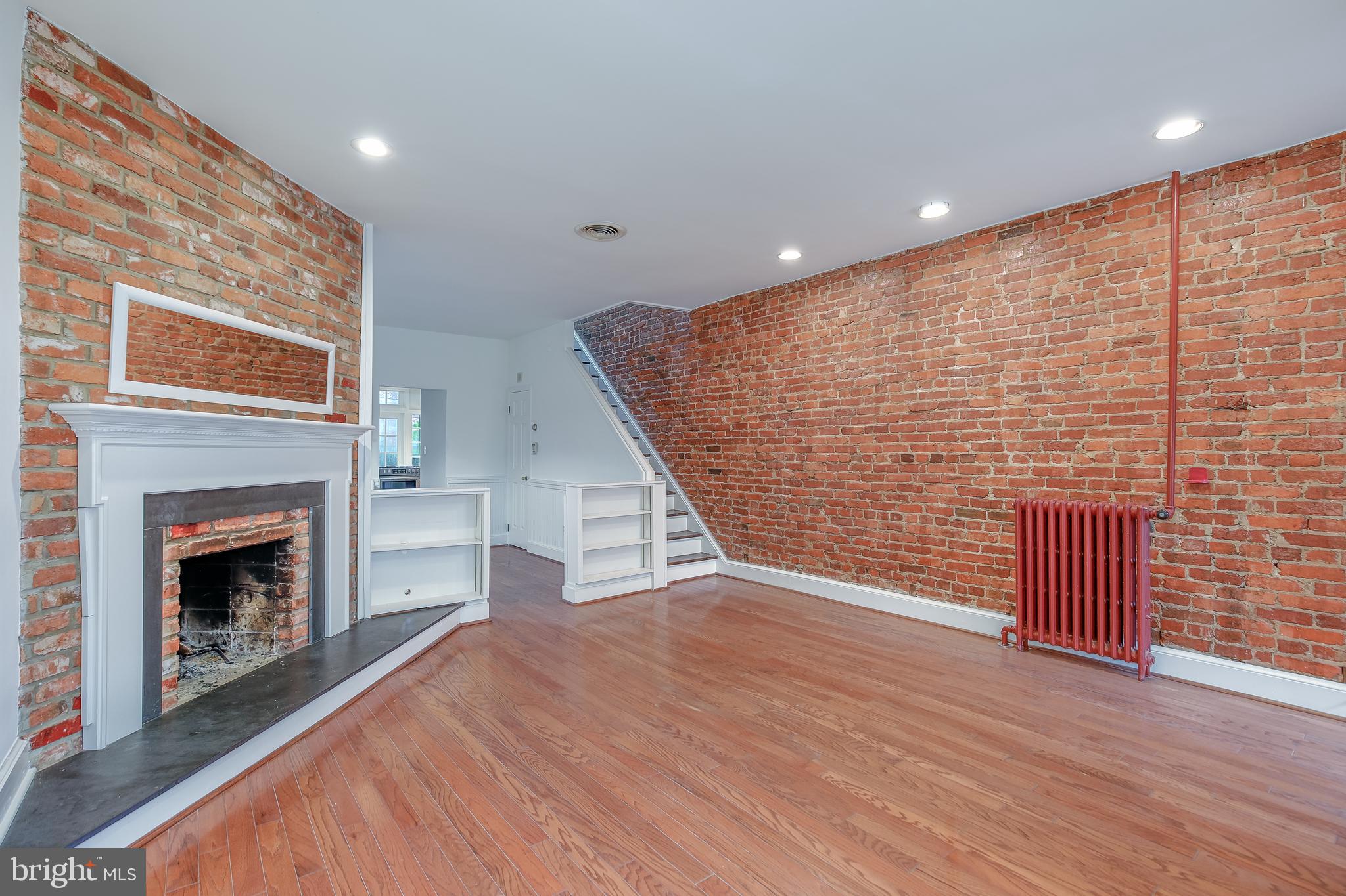 323 14th Street Northeast Washington, DC 20002 - Photo 9 of 41 an empty room with wooden floor fireplace and windows