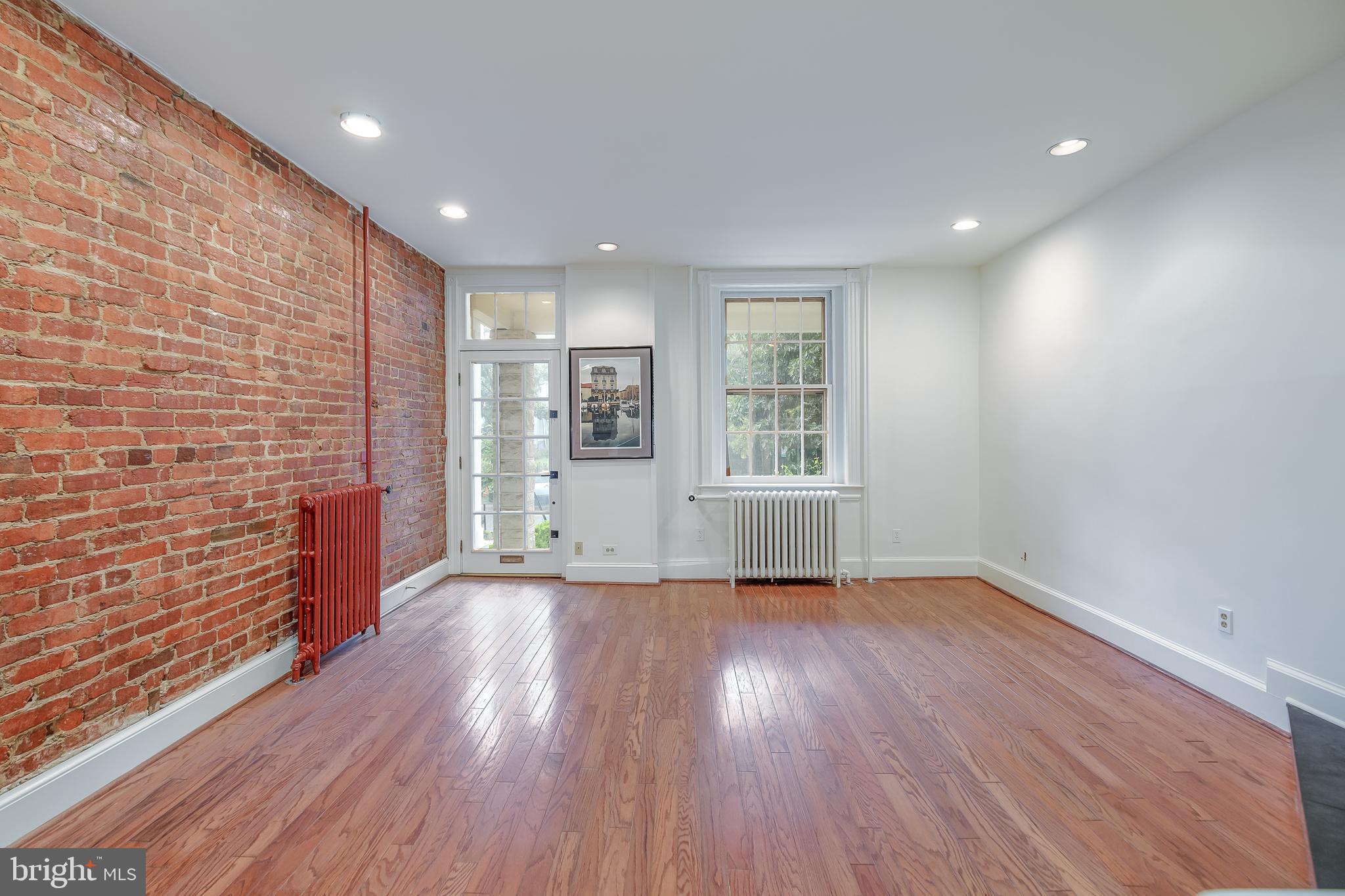 323 14th Street Northeast Washington, DC 20002 - Photo 10 of 41 a view of an empty room with a window and wooden floor