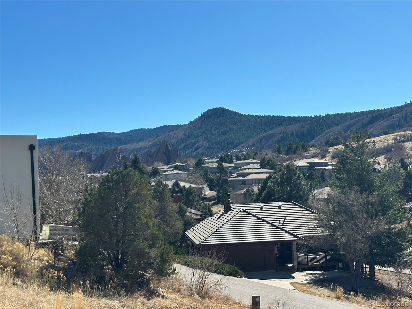 6668 Old Ranch Trail Littleton, CO 80125 - Photo 4 of 5 a view of a house with a mountain yard