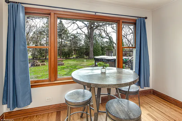 a view of a dining room with furniture and a window
