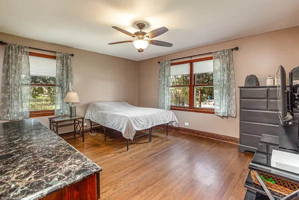 a spacious bedroom with a bed and a dresser