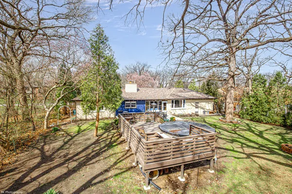 a view of a patio with table and chairs under an umbrella