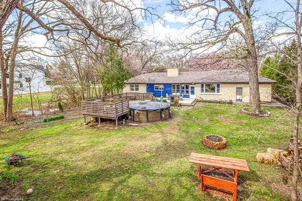 a backyard of a house with yard table and chairs