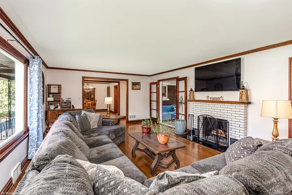 a living room with furniture fireplace and flat screen tv