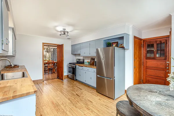a kitchen with a refrigerator and a sink