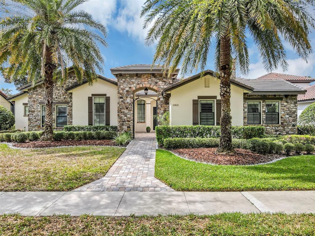 11821 Waterstone Loop Drive Windermere, FL 34786 - Photo 1 of 1 a front view of a house with a garden