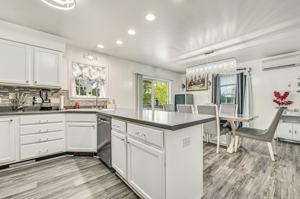 15 Jackson Road Webster, MA 01570 - Photo 17 of 31 a kitchen with granite countertop kitchen island white cabinets and white appliances