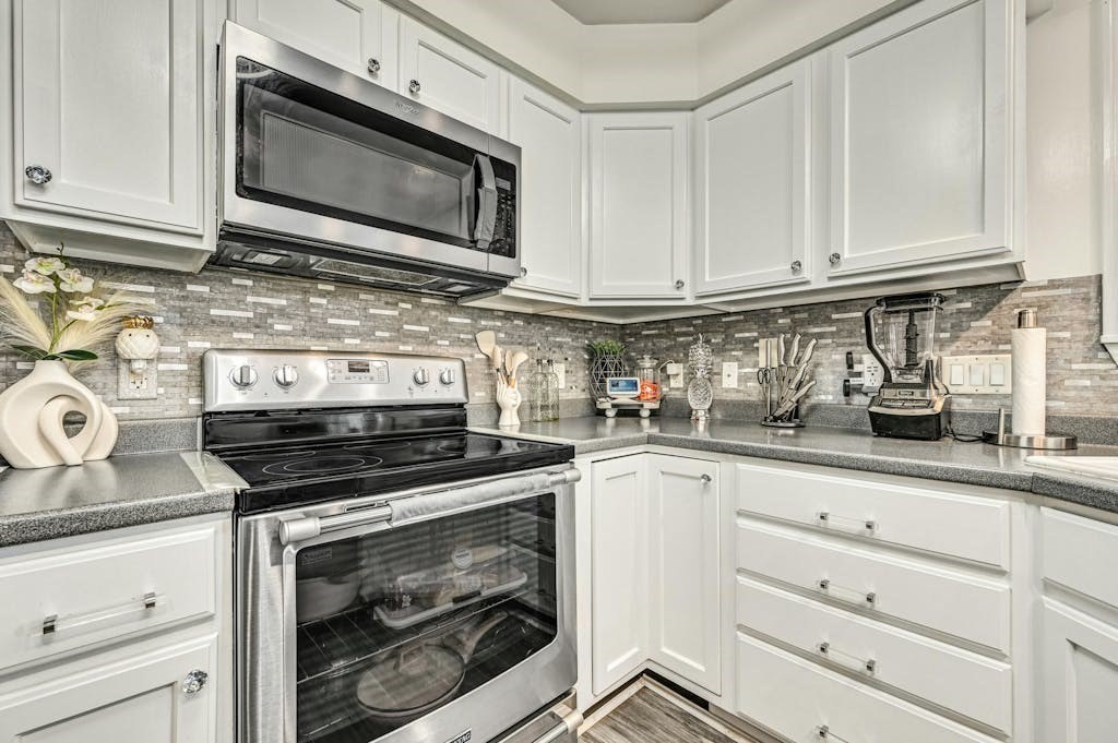15 Jackson Road Webster, MA 01570 - Photo 19 of 31 a kitchen with granite countertop white cabinets and appliances