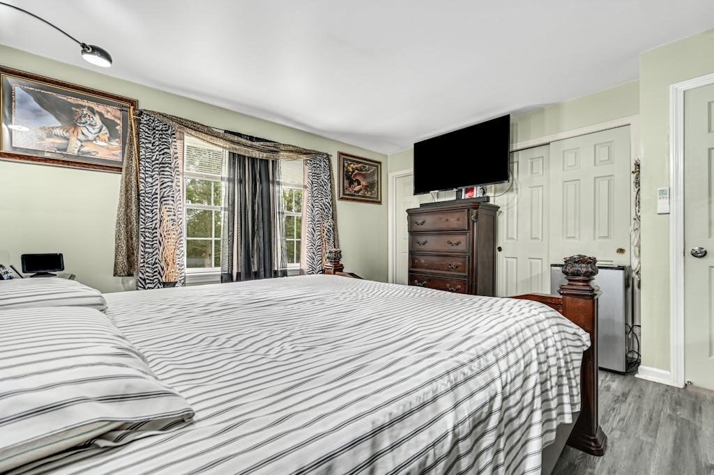 15 Jackson Road Webster, MA 01570 - Photo 20 of 31 a bedroom with a bed and a flat screen tv