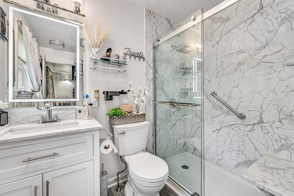 15 Jackson Road Webster, MA 01570 - Photo 21 of 31 a bathroom with a sink toilet vanity and shower