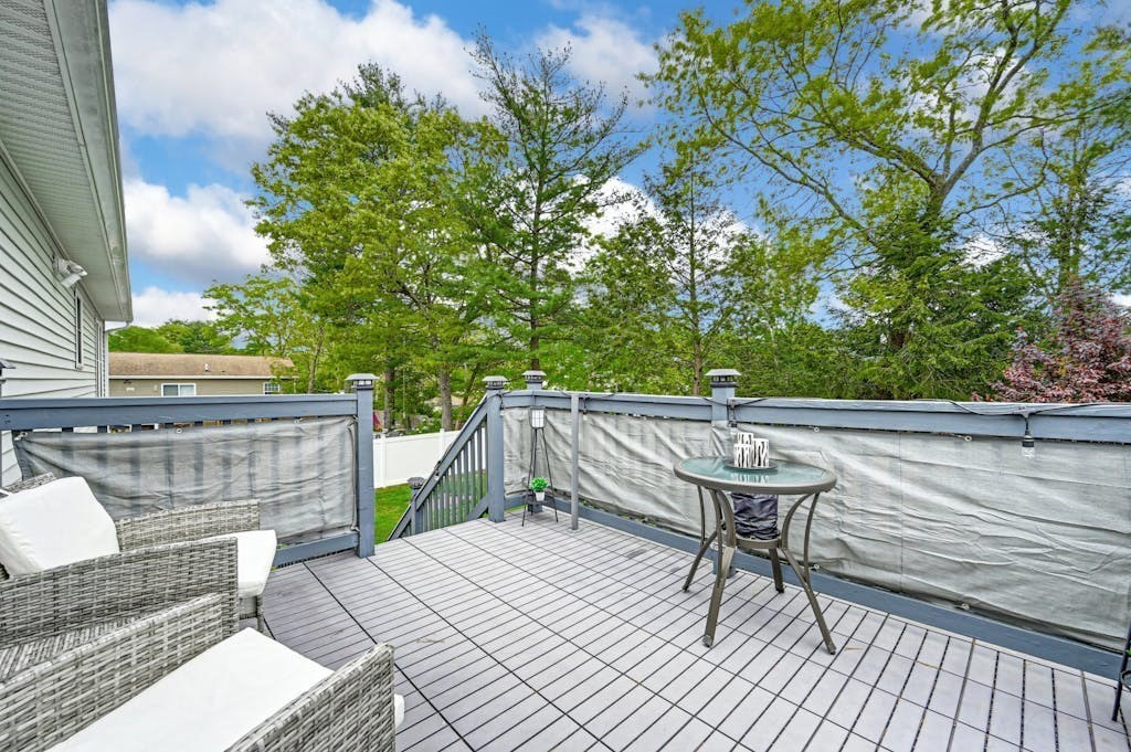15 Jackson Road Webster, MA 01570 - Photo 26 of 31 a balcony with wooden floor and outdoor seating
