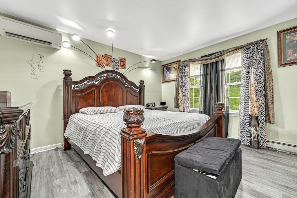 15 Jackson Road Webster, MA 01570 - Photo 5 of 31 a bedroom with a bed and wooden floor