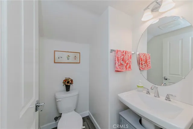 a bathroom with a sink mirror vanity and toilet