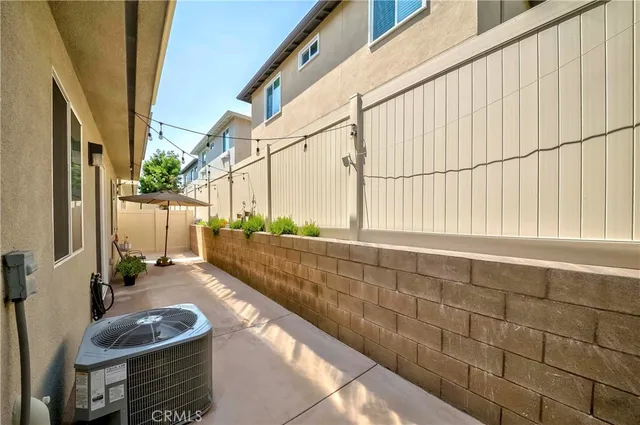 a view of a patio with couches and potted plants