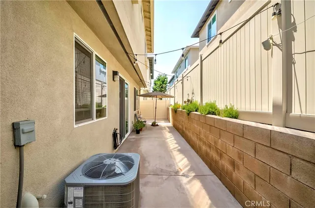 a view of a patio with a table and chairs under an umbrella