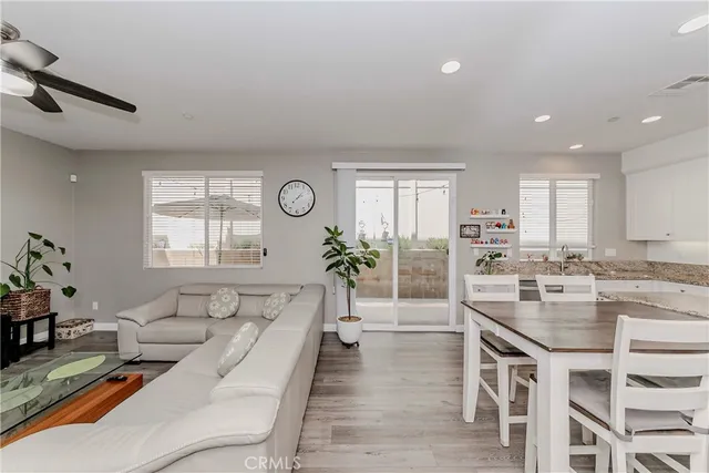 a living room with kitchen island furniture and a wooden floor