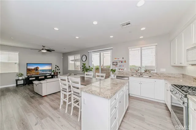 a kitchen with sink stove and cabinets