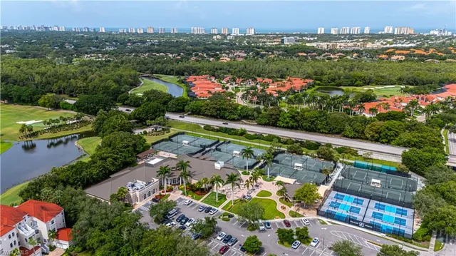 an aerial view of residential houses with outdoor space and swimming pool
