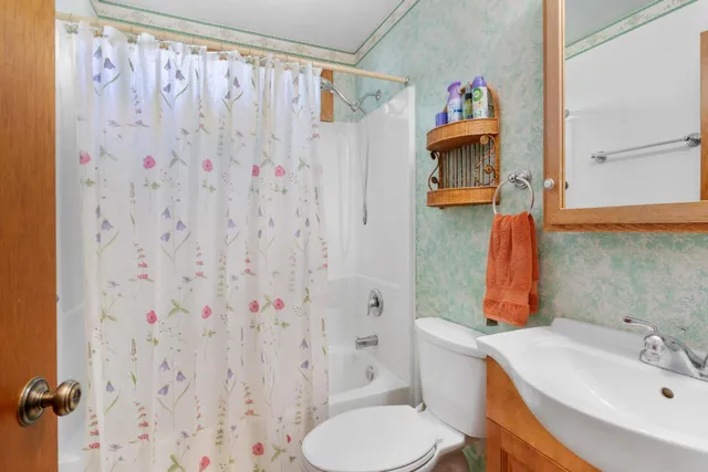 a bathroom with a toilet and shower