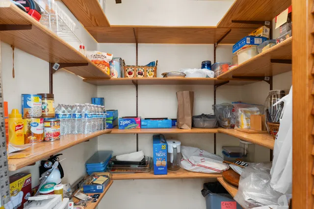 a view of a dining room with furniture a chandelier and wooden floor