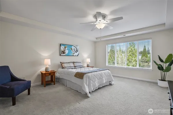 a bedroom with bed and a chandelier