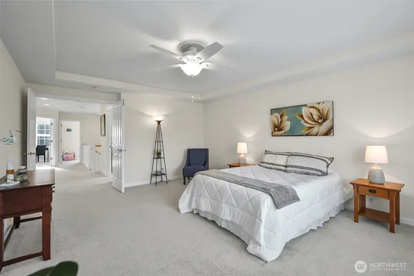 a bedroom with a bed and a potted plant