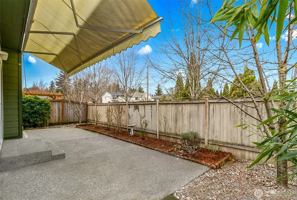 a view of a pathway of a house with a backyard