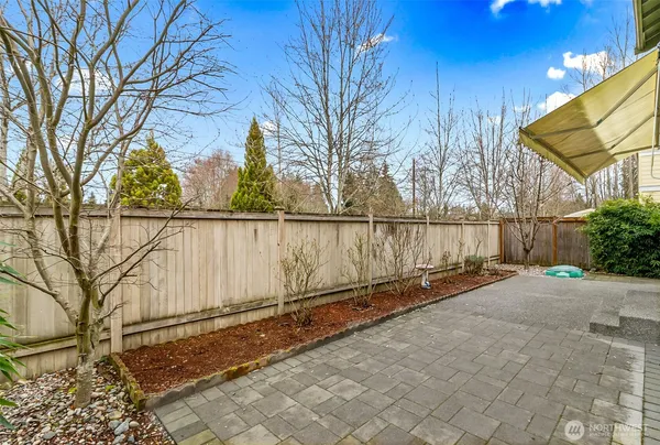 a front view of a house with a yard and potted plants