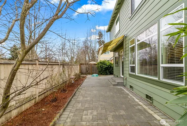 a view of a yard with wooden fence