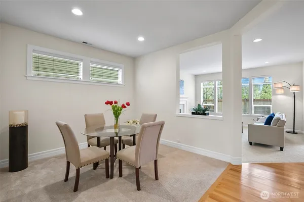 a dining room with furniture and flowers