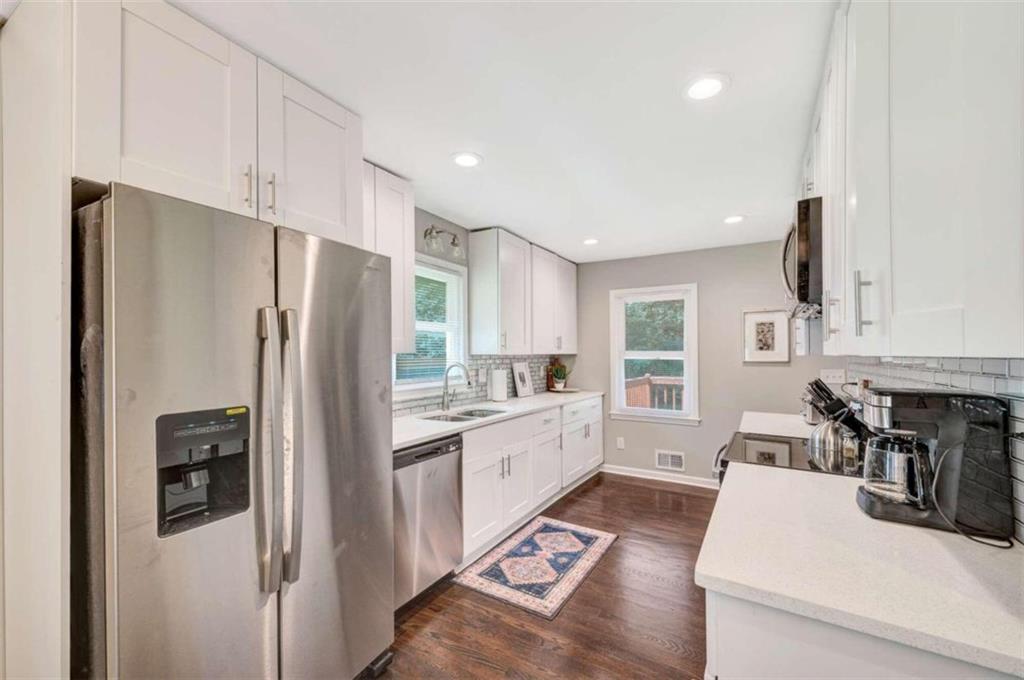 1376 Sandtown Road Southwest Marietta, GA 30008 - Photo 11 of 25 a kitchen with stainless steel appliances a refrigerator sink and stove