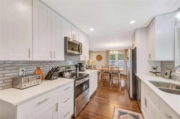 a kitchen with a sink stove and cabinets