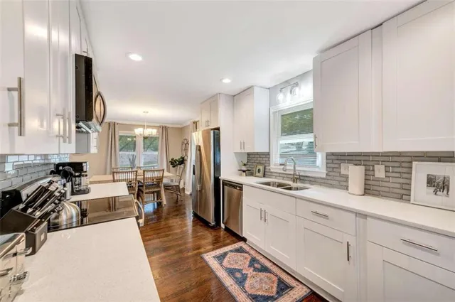 a very nice looking room with a large window and furniture