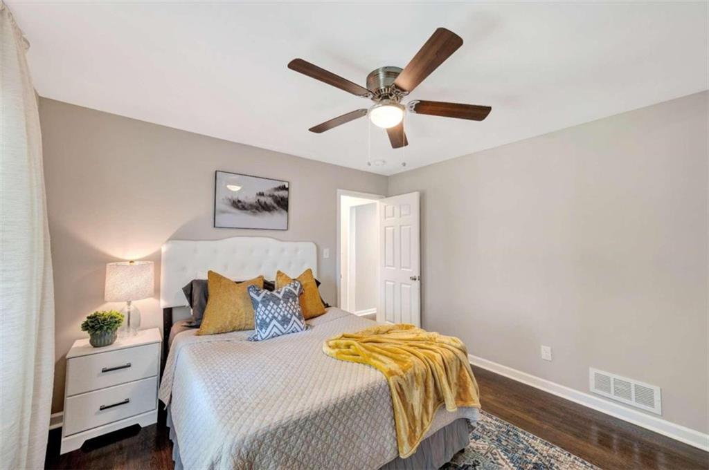 1376 Sandtown Road Southwest Marietta, GA 30008 - Photo 20 of 25 a bedroom with a bed and a chandelier