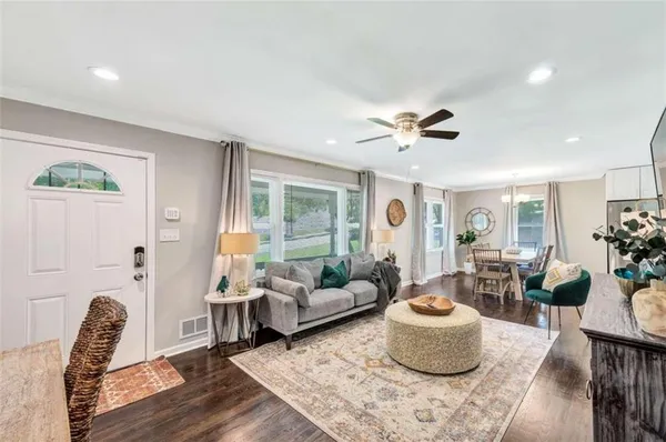 a living room with furniture and wooden floor