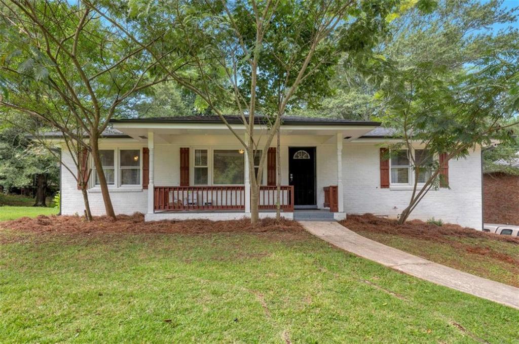 1376 Sandtown Road Southwest Marietta, GA 30008 - Photo 23 of 25 a view of a house with a yard and large tree