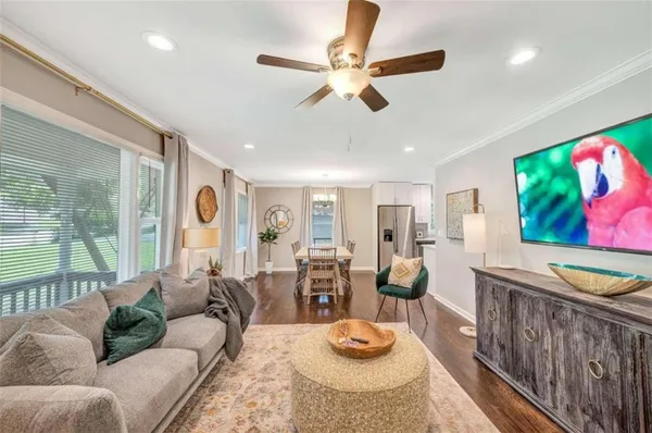 a living room with furniture and wooden floor