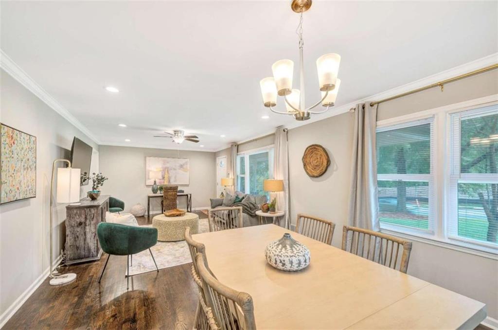 1376 Sandtown Road Southwest Marietta, GA 30008 - Photo 7 of 25 a view of a dining room with furniture a chandelier and wooden floor