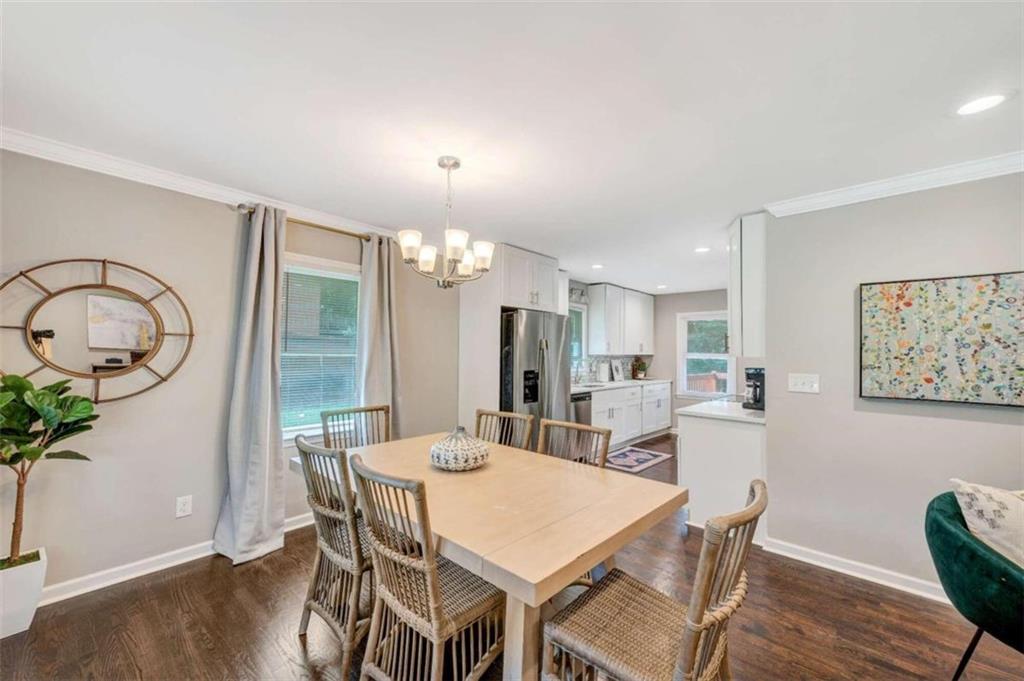 1376 Sandtown Road Southwest Marietta, GA 30008 - Photo 10 of 25 a view of a dining room with furniture window and wooden floor